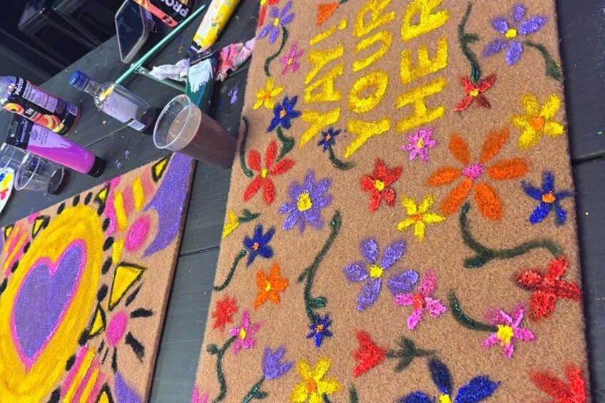 A colorful rug with a message and a heart design. 3