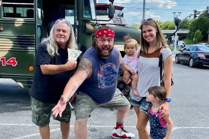 A family of four in front of a green bus with the number 14. 4
