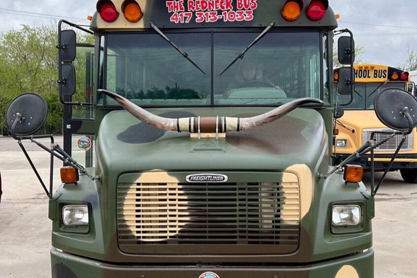 A vintage school bus with a large bullhorn on the front. 3