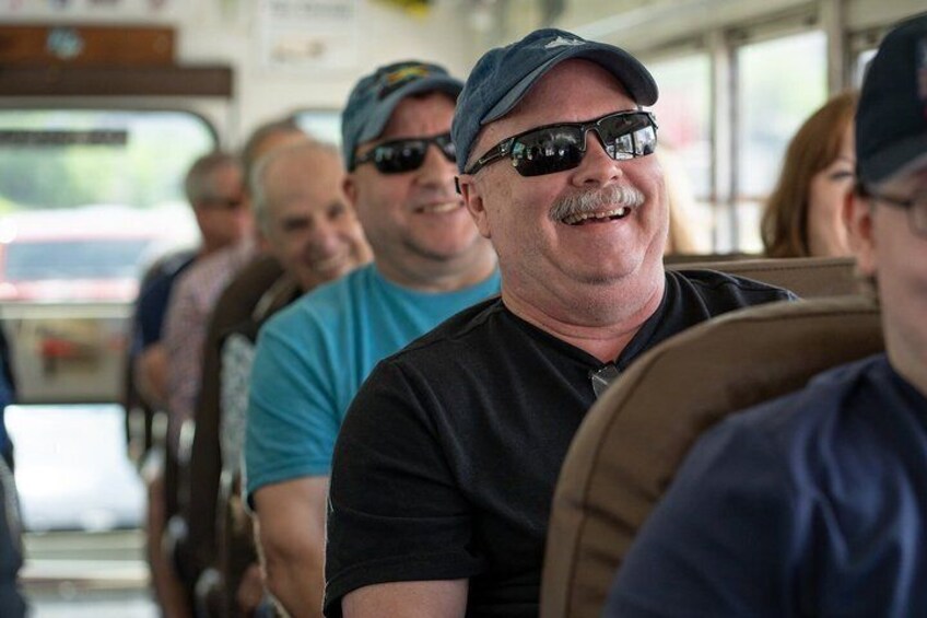 People seated inside a bus. 5