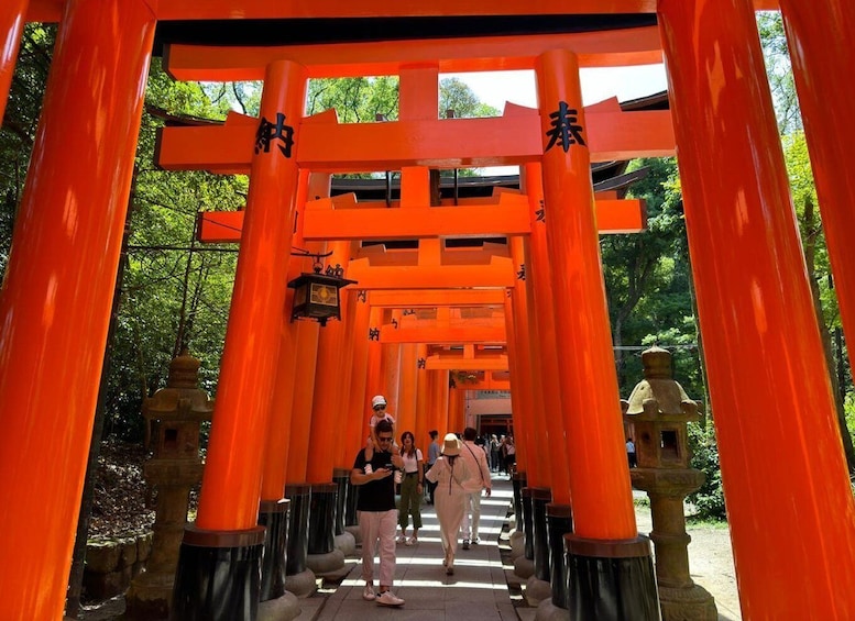 A row of bright orange torii gates leading into a forested area. 5