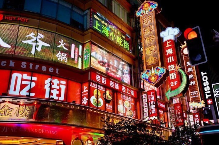A brightly lit street with neon signs, including one for 'Shanghai Hot Pot' and another for 'Shanghai Street.' 5