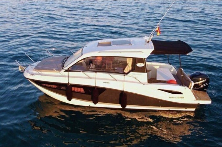 A white and brown motorboat on calm water. 1