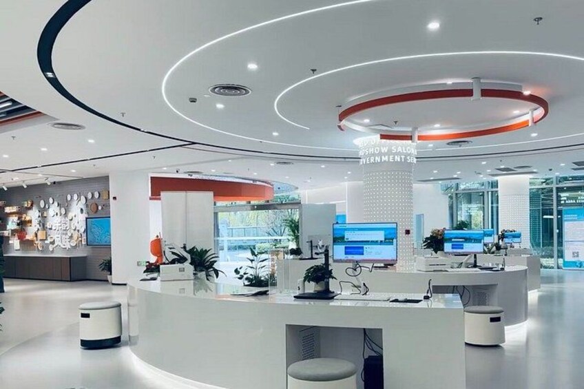 A modern reception area with a circular design, multiple computer monitors, and a clean, white color scheme. 5