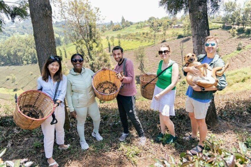 A group of people holding baskets in a rural setting with trees and fields in the background. 1
