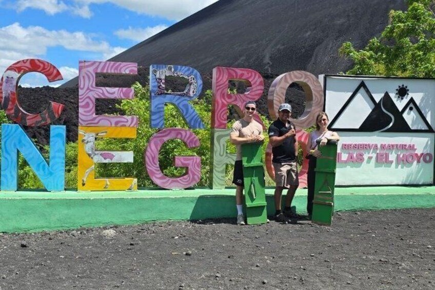 A colorful sign with the text 'CERRO NEGRA' and a mountain in the background. 2