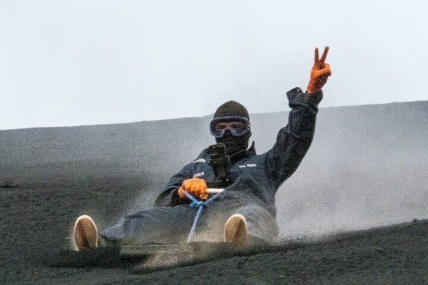 A person sledding down a slope. 5