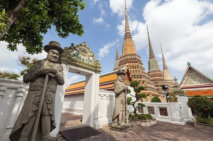 A temple complex with multiple spires and stone statues. 3