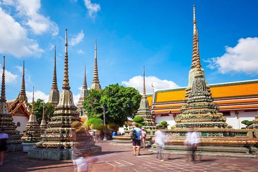 A temple complex with multiple ornate spires and a clear blue sky. 2