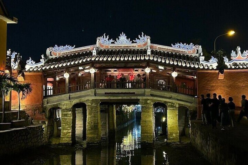 A traditional Chinese building with a tiled roof and ornate decorations, situated over a body of water. 4
