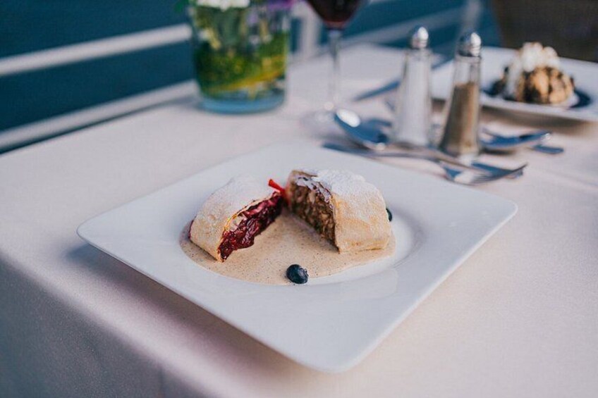 A dessert on a white plate with a blue background. 5