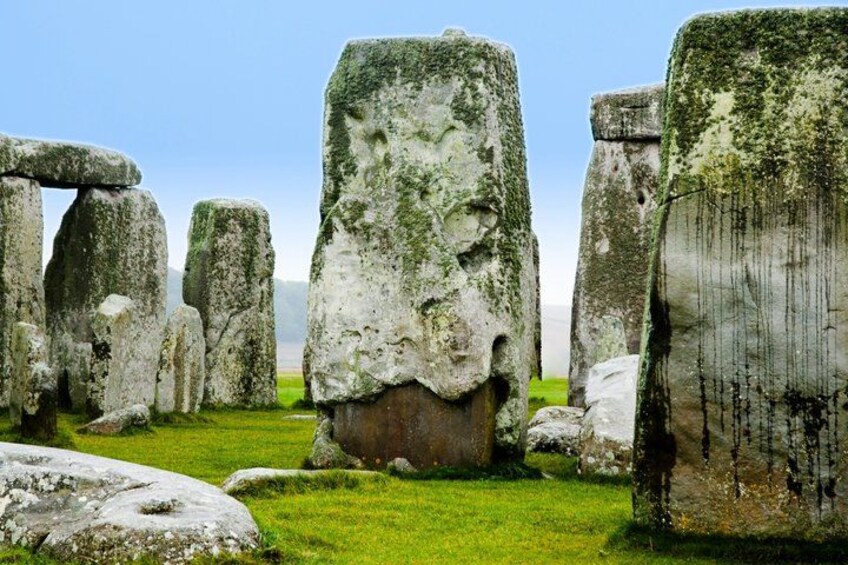 Stonehenge standing in a grassy field. 1