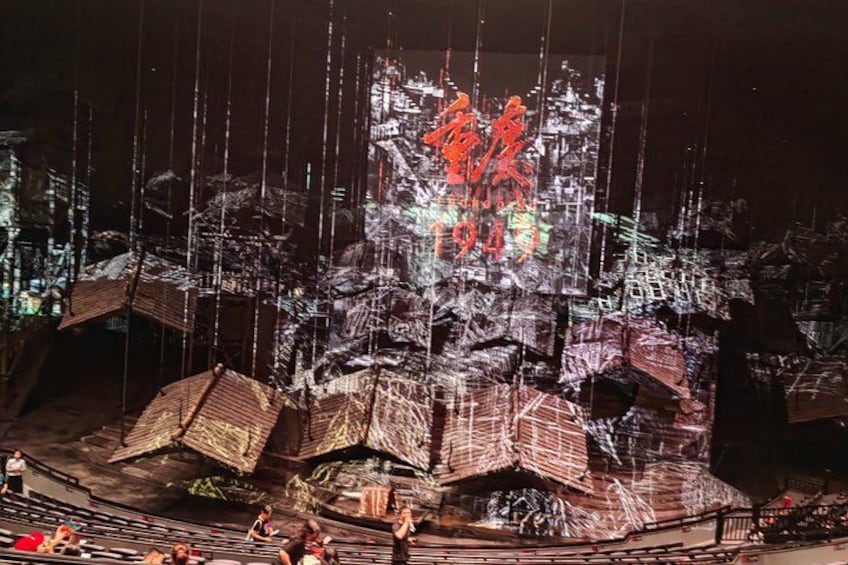 A large outdoor theater with a stage and audience seating. 1