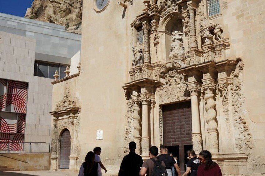 A historic building with ornate carvings and a clock. 1