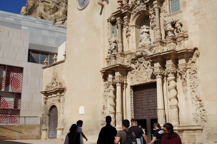 A historic building with ornate carvings and a large wooden door. 1