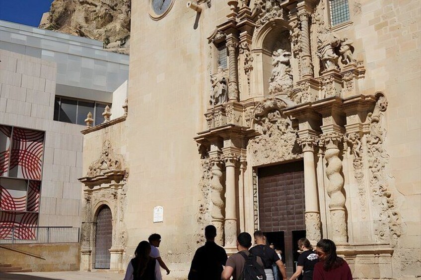 A historic building with ornate carvings and a large wooden door. 1