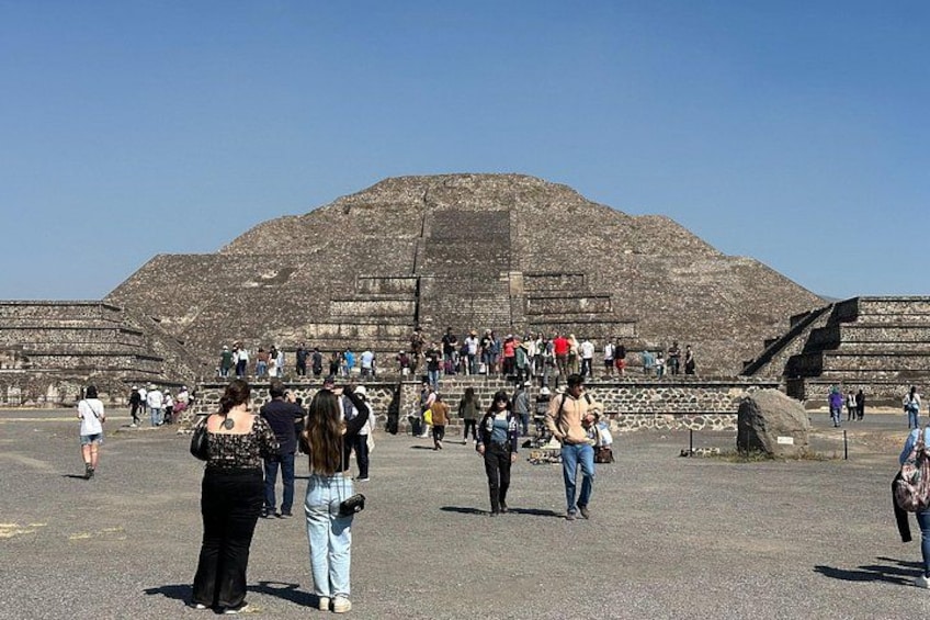A large pyramid with people walking around it. 5