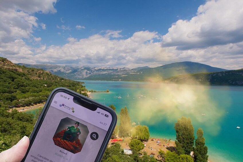 A smartphone displaying a photo of a scenic landscape with a lake, mountains, and trees. 5