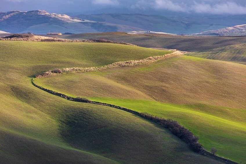Rolling hills with a stone wall meandering through the landscape. 2