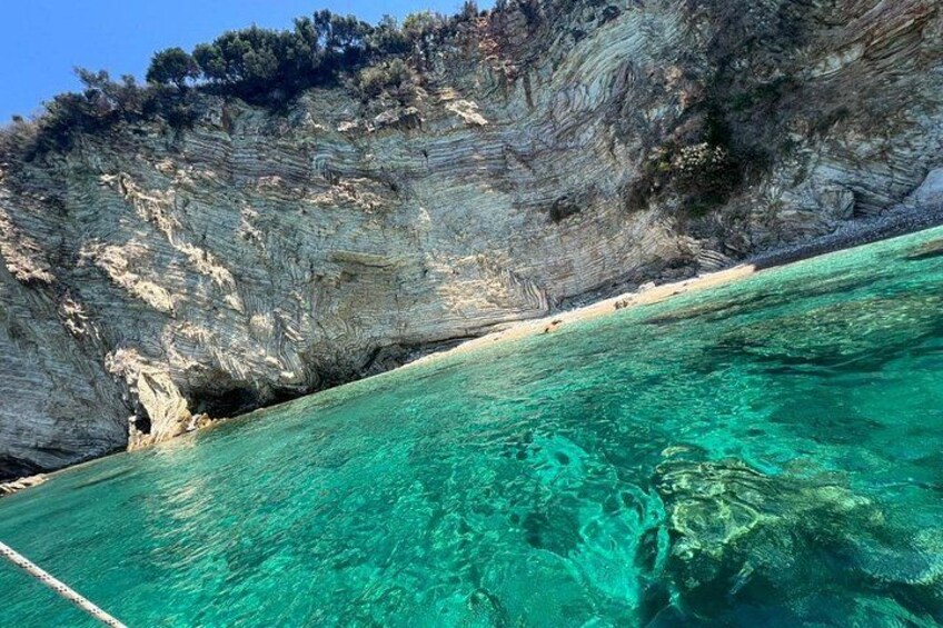 A coastal cliff with clear turquoise water. 4