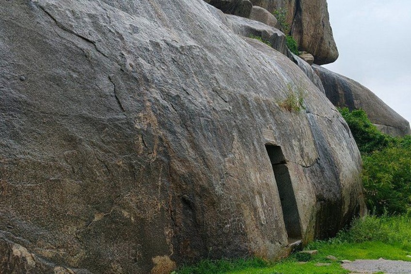 A large rock formation with a cave entrance. 4