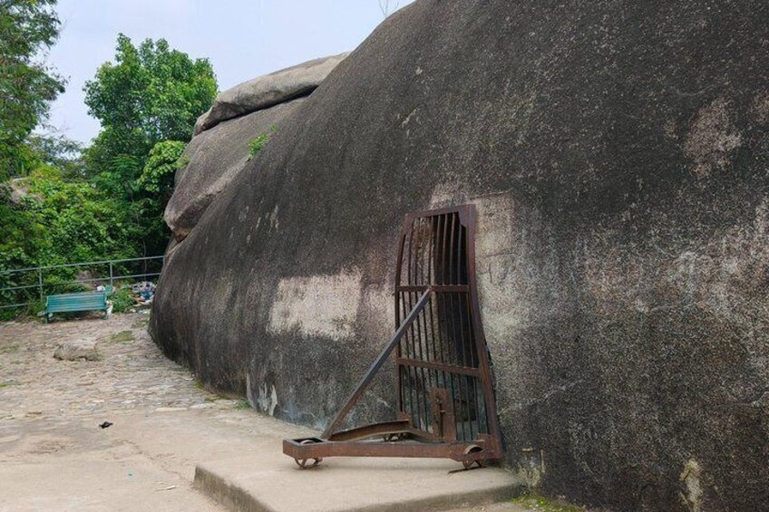 A large rock formation with a metal gate. 5