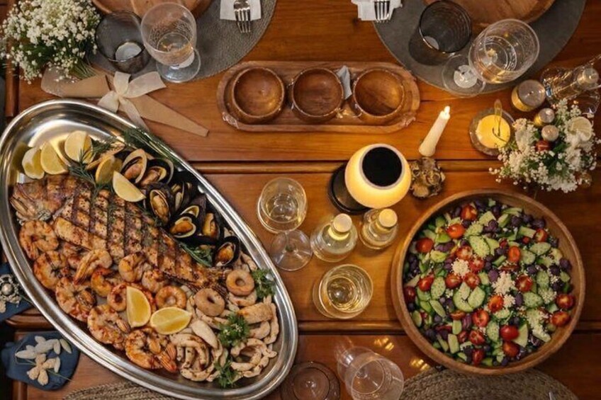 A seafood platter, a salad, and a candle-lit table setting. 4