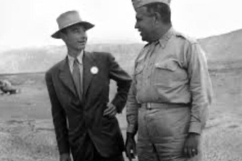 Two men in suits standing in a barren landscape with a flat horizon. 3