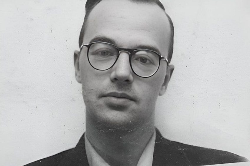 A person wearing glasses and a dark jacket. 3
