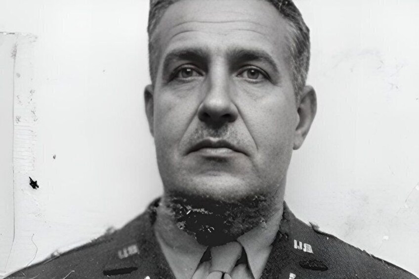 A man in a military uniform with a tie and a badge on his chest. 2
