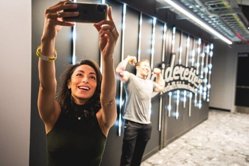 A person taking a selfie in front of a wall with a sign that reads 'Lidette.' 5