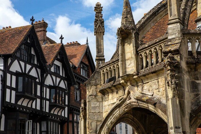 A historic building with a pointed archway and a traditional timber-framed structure. 4