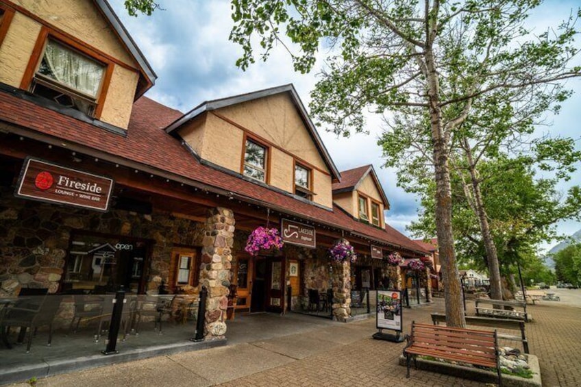 A stone building with a sign for Fireside, a wine bar, and outdoor seating. 5