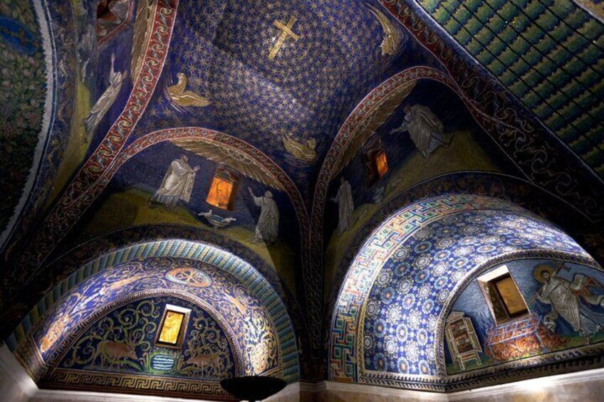 A domed ceiling with intricate mosaics and a cross. 2