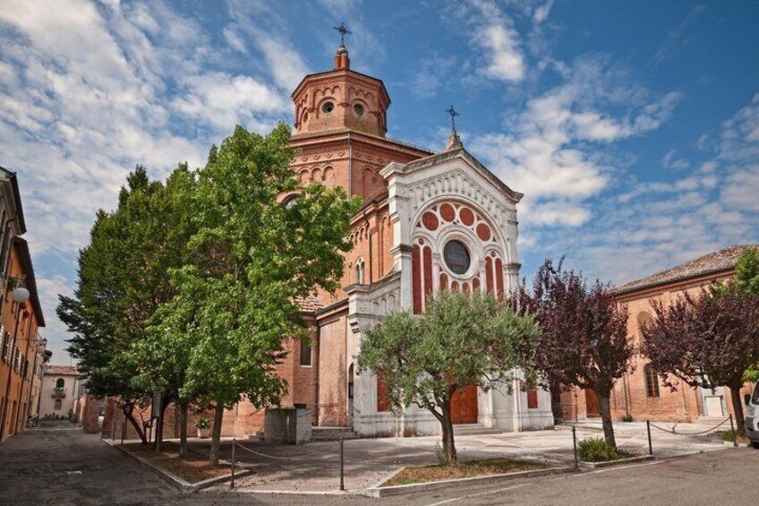 A church with a red dome and white facade, surrounded by trees and a clear sky. 3
