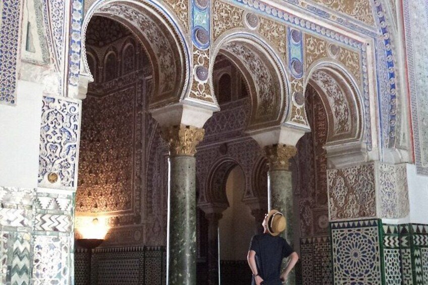 An ornate architectural interior with intricate tile work and arches. 4