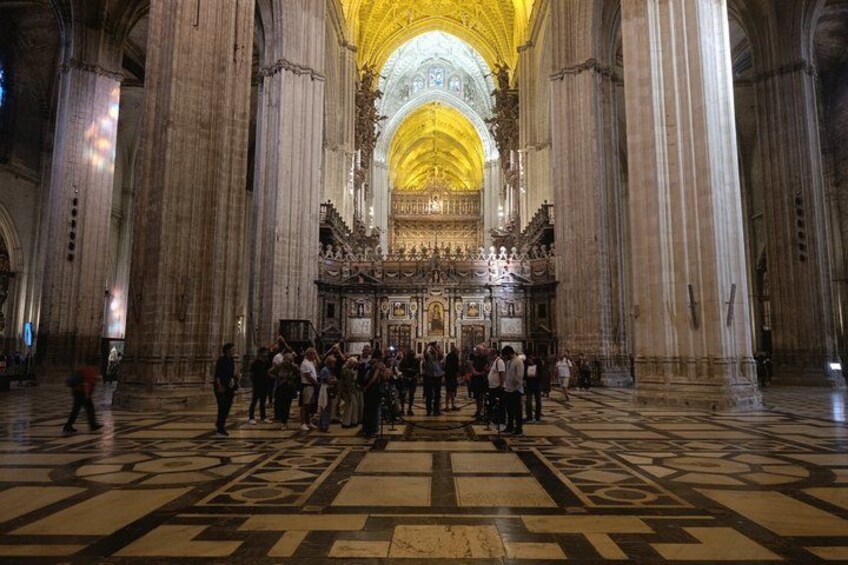 A cathedral interior with high vaulted ceilings and a central altar. 4