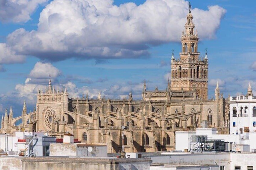 A historic cathedral with intricate architecture, a prominent clock tower, and a large rose window. 2