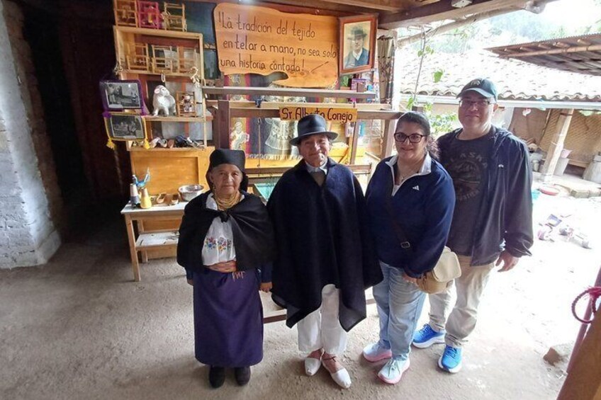 A group of people in a rustic shop with wooden shelves and a signboard. 2