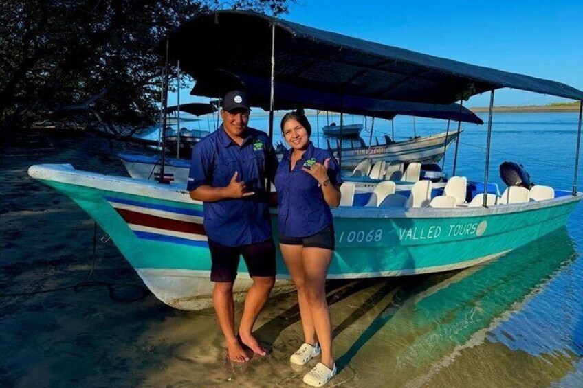 Two people standing next to a boat with 'Valled Tours' written on it. 3