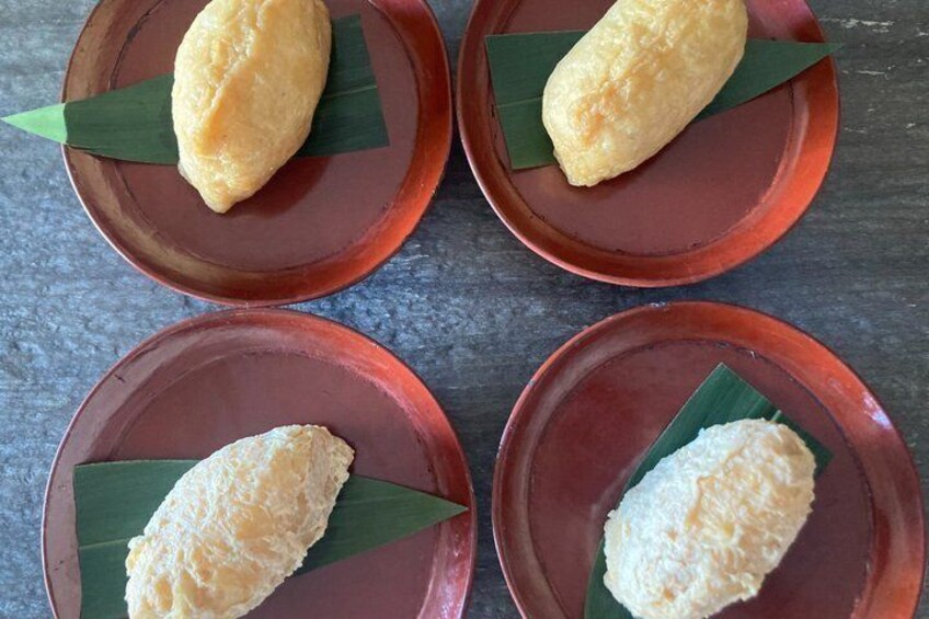 Four round plates with a food item on top, each placed on a green leaf. 3