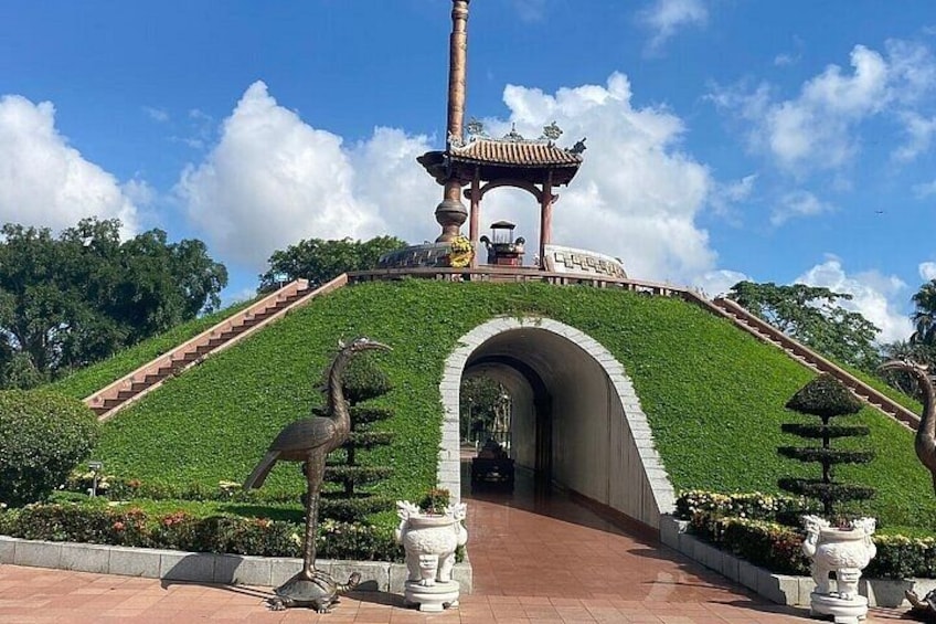A landscaped garden with a central archway, a pagoda, and a statue of a bird. 5