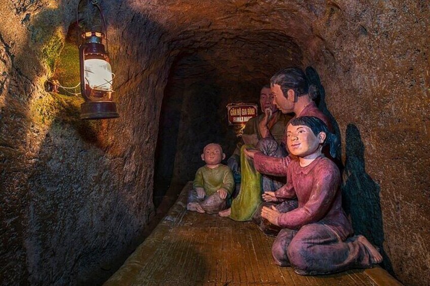 A cave with a lantern hanging from the ceiling and a sign with text. 4