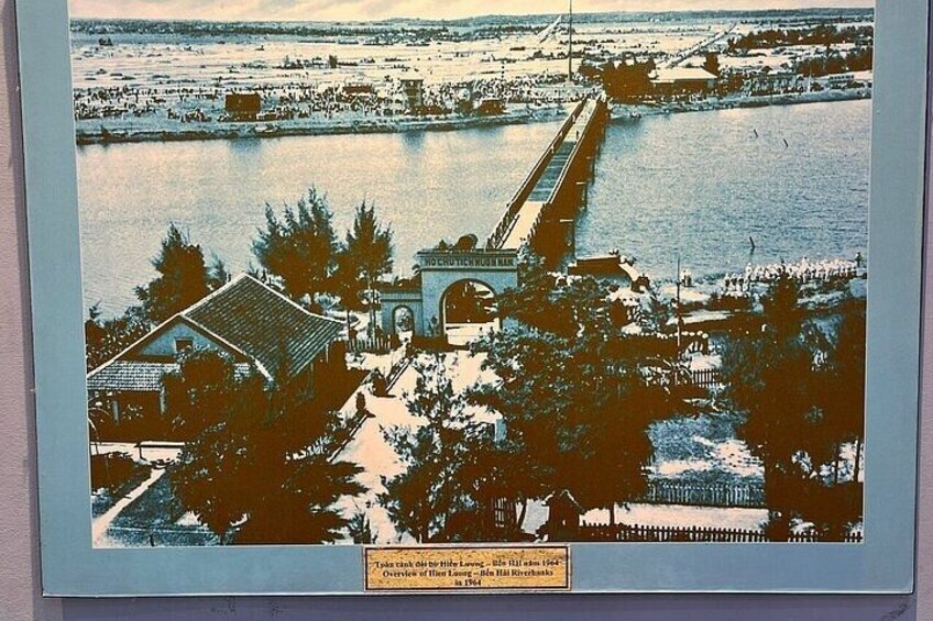 A river with a bridge, a building, and trees. 3