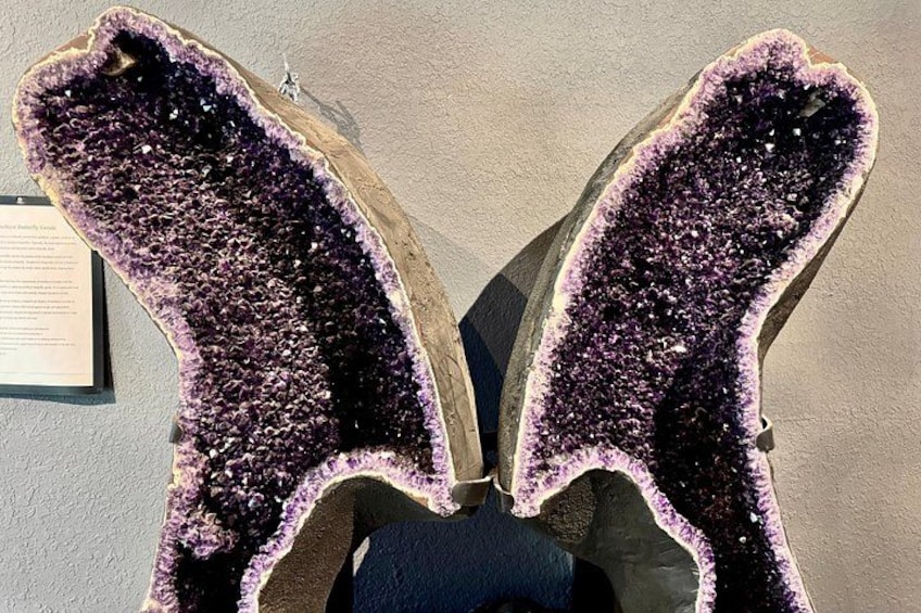 A purple geode with a rough texture and a wooden frame. 4