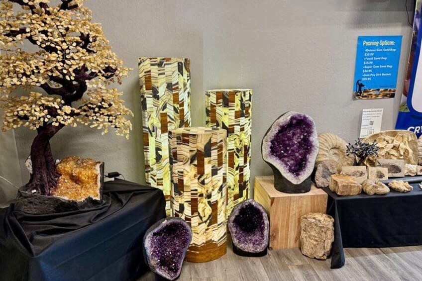 A display of geological specimens including a tree, a patterned wooden structure, and various crystals. 1