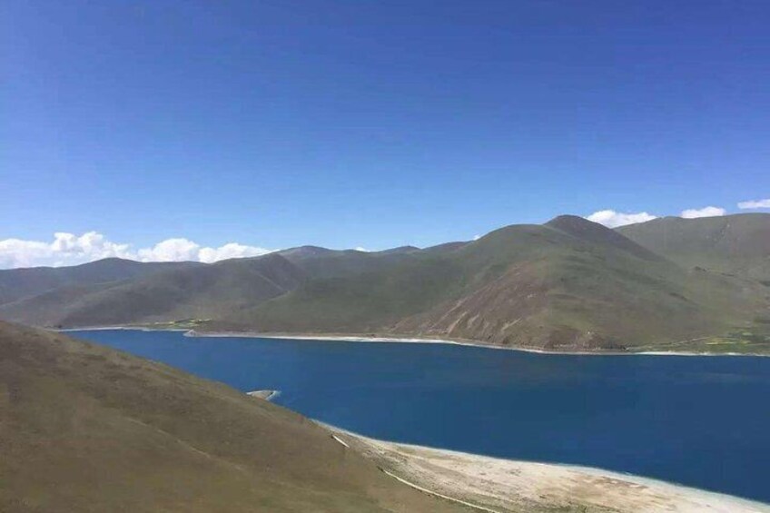 A mountainous landscape with a lake and clear blue sky. 3