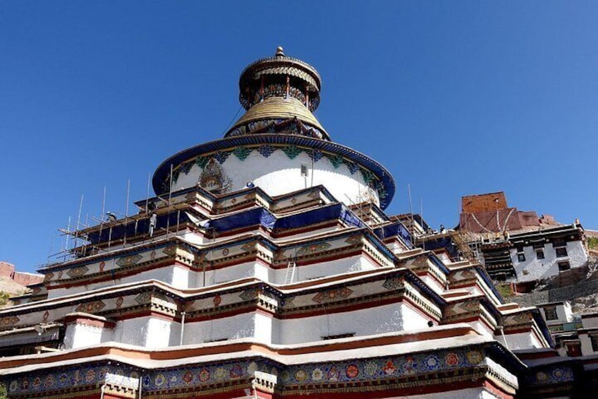 A multi-tiered temple with intricate patterns and a golden dome. 4