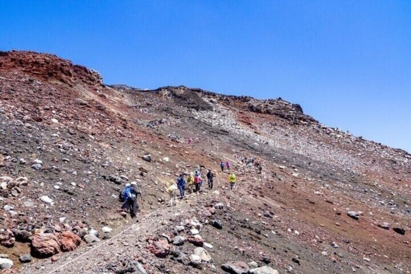 A rocky mountain trail with hikers. 2