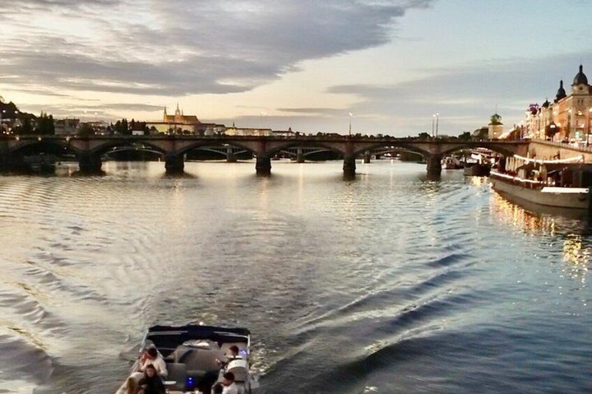 A river with a bridge, boats, and buildings along the riverbank. 4